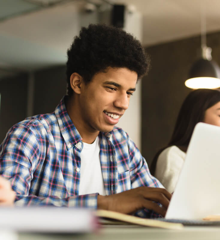 A male student on his laptop.