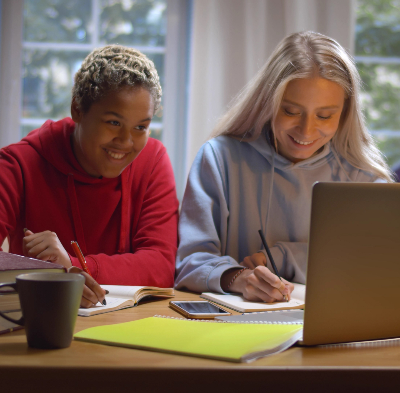 Two girls doing homework in the library.